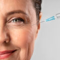 smiley-elder-woman-using-injection-her-eye-wrinkles