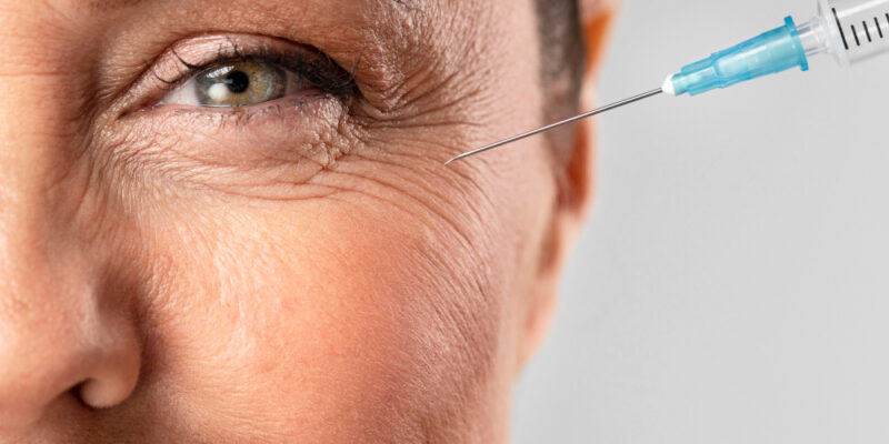 smiley-elder-woman-using-injection-her-eye-wrinkles